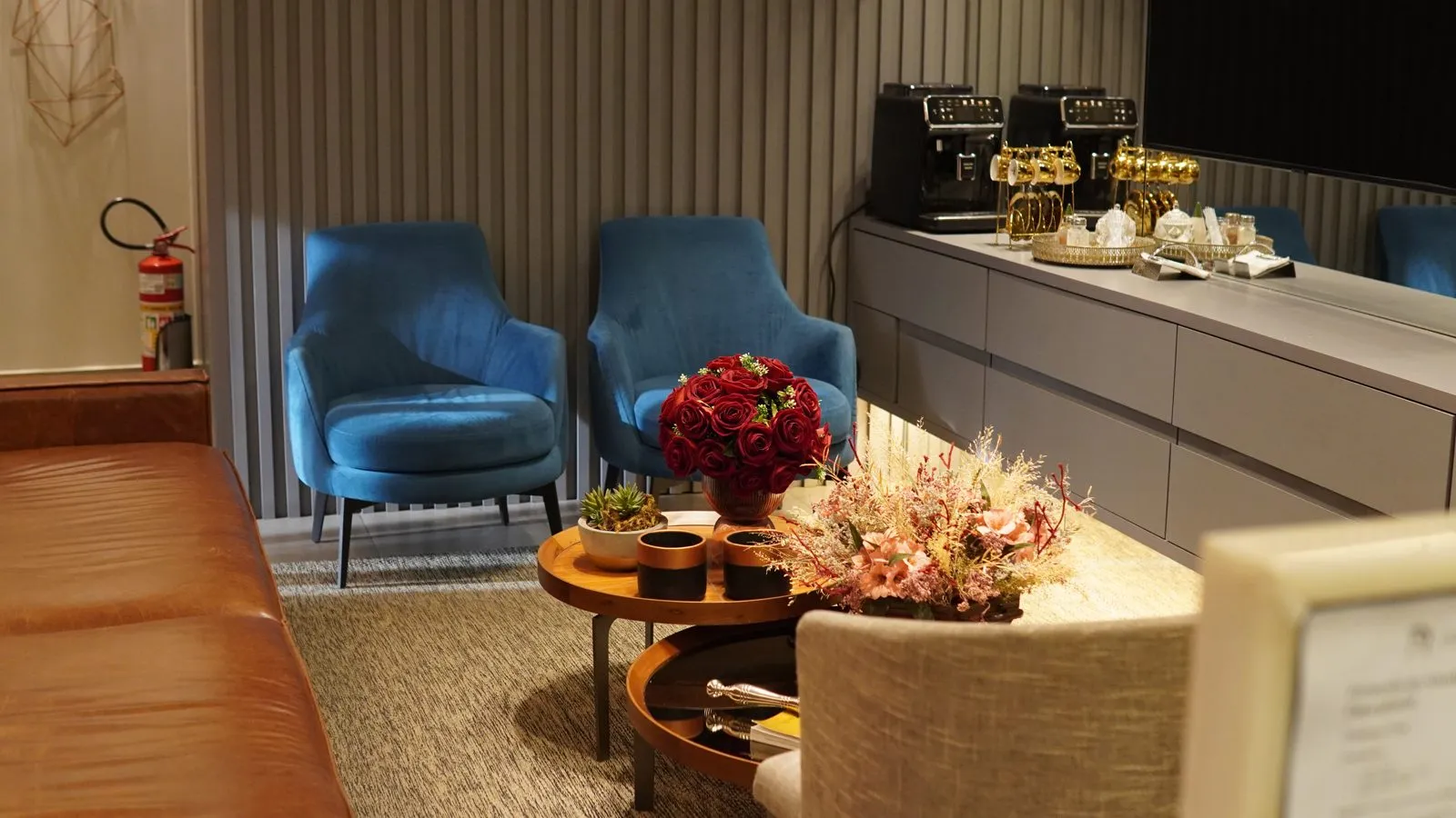 Waiting room with blue armchairs and flowers