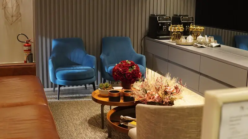 Waiting room with blue armchairs and flowers
